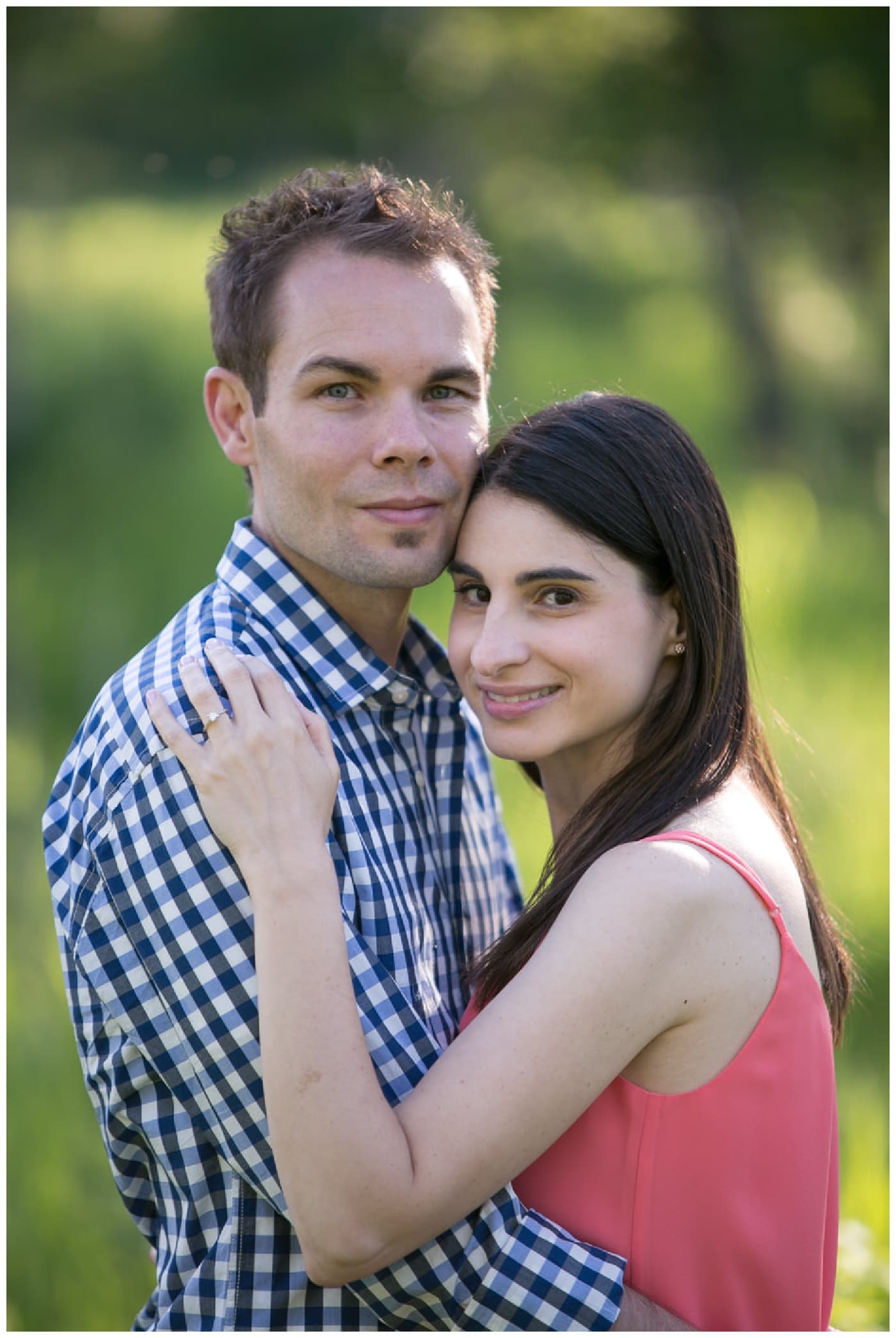 Fish Creek Park Engagement with a newly engaged couple and their dog, beautiful green trees, bridegs, and setting sunlight