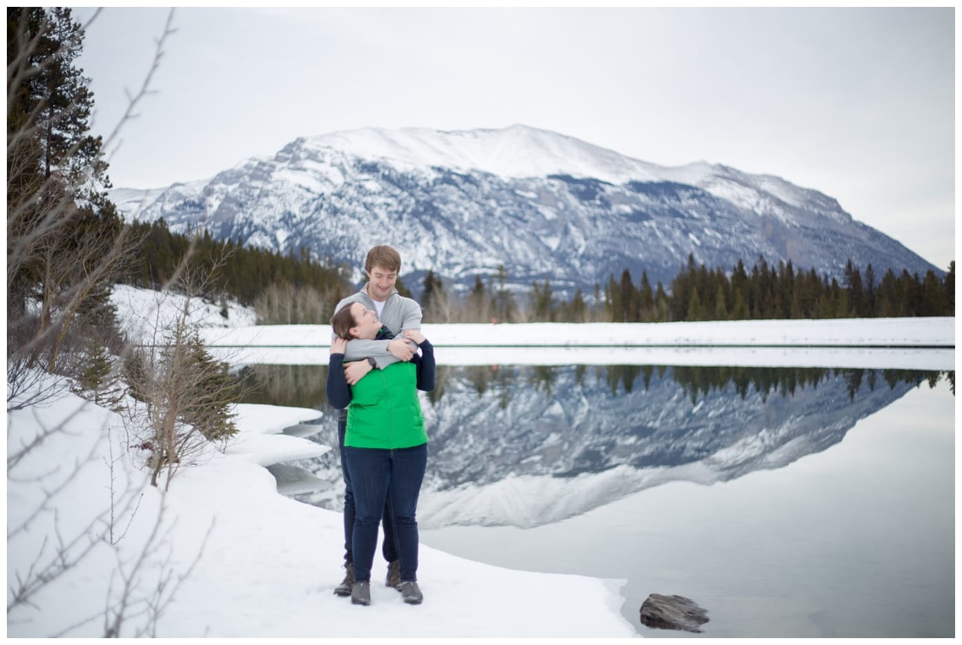 Calgary engagement session in the Rocky Mountains at Grassi Lakes with the couple standing in front of a beuatiful mountain view