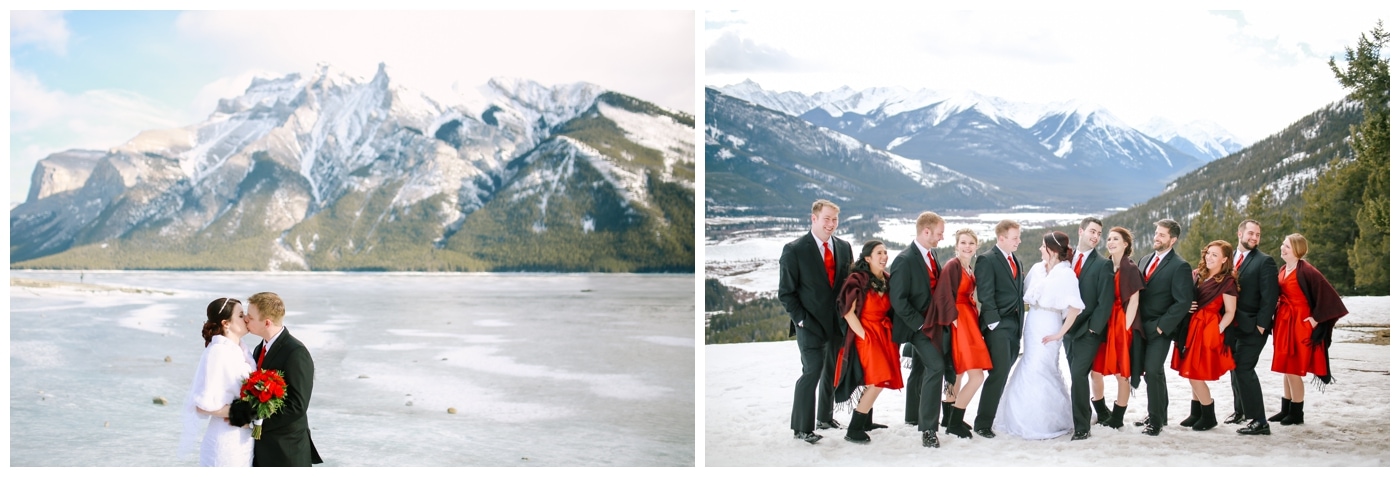 A wedding party dressed in red stands in the Rocky Mountains in Banff with snow at their feet and mountains behind them