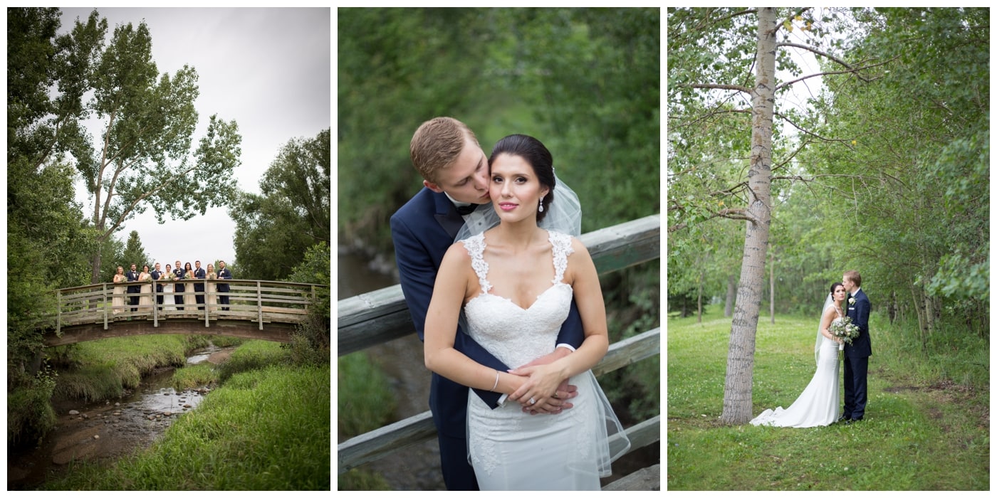 A bridal party stands on a bridge, a bride looks on as her husband gently kisses her cheek, and the bride and groom stand in a forested park