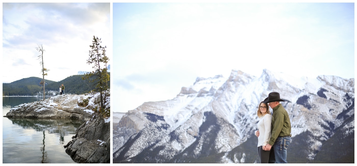 An engagement session in Banff with the couple posing next to Lake Minnewanka with mountains in the background