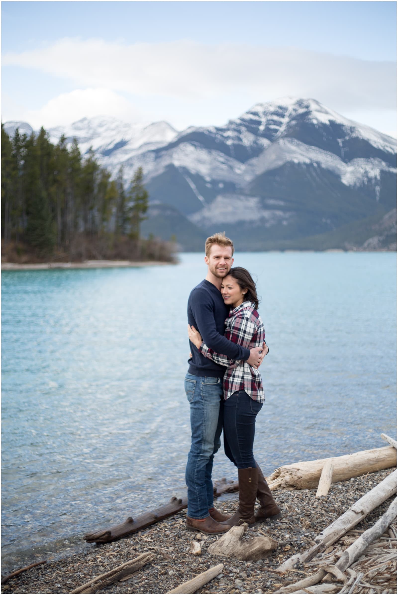 A beautiful adventure engagement session in the Rocky Mountains of Alberta at Barrier Lake, Kananaksis, and Spray Lakes with 360 mountain views and snow