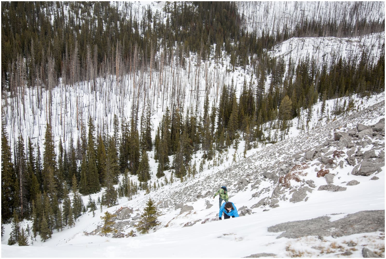 A beautiful adventure engagement session in the Rocky Mountains of Alberta at Barrier Lake, Kananaksis, and Spray Lakes with 360 mountain views and snow