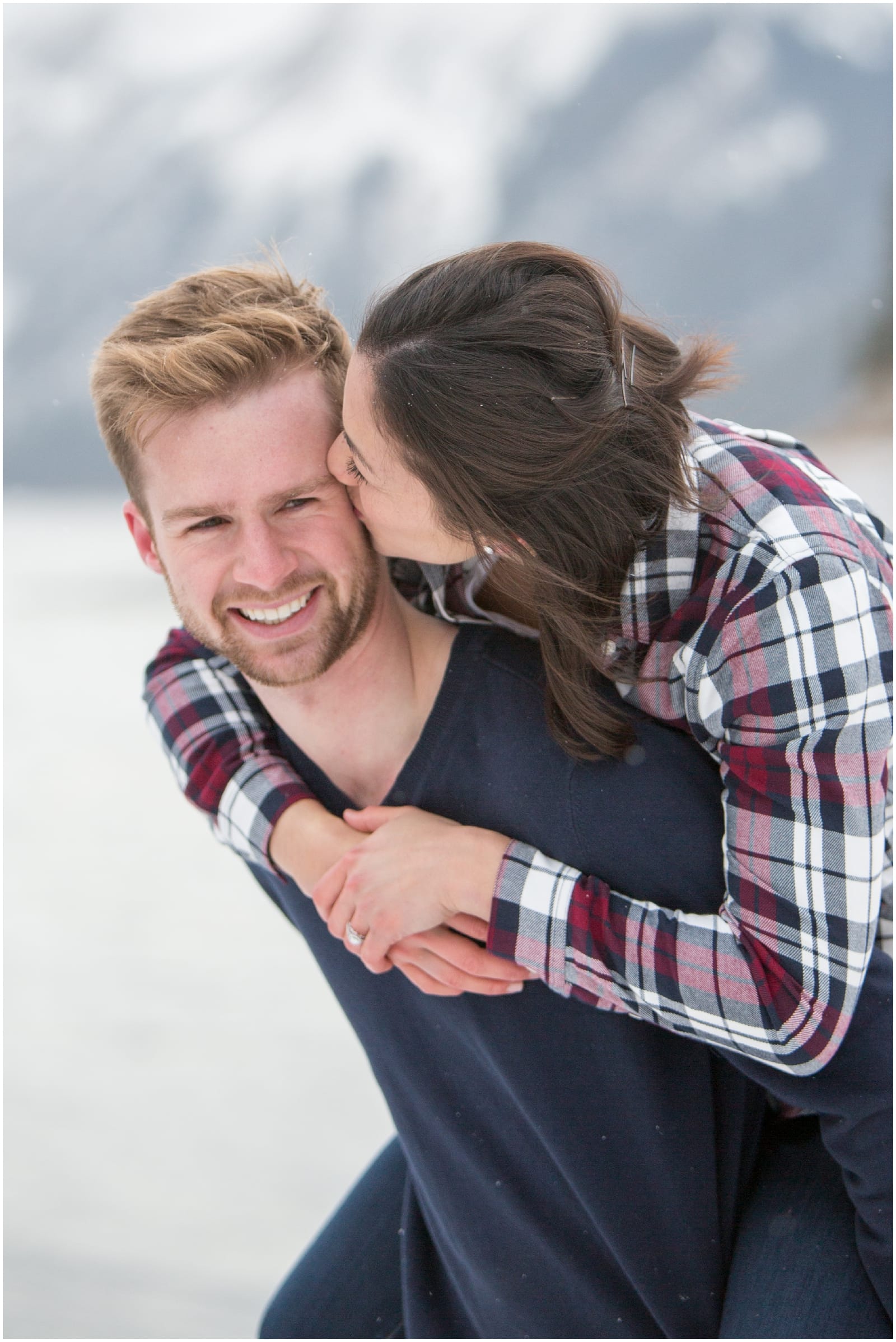 A beautiful adventure engagement session in the Rocky Mountains of Alberta at Barrier Lake, Kananaksis, and Spray Lakes with 360 mountain views and snow