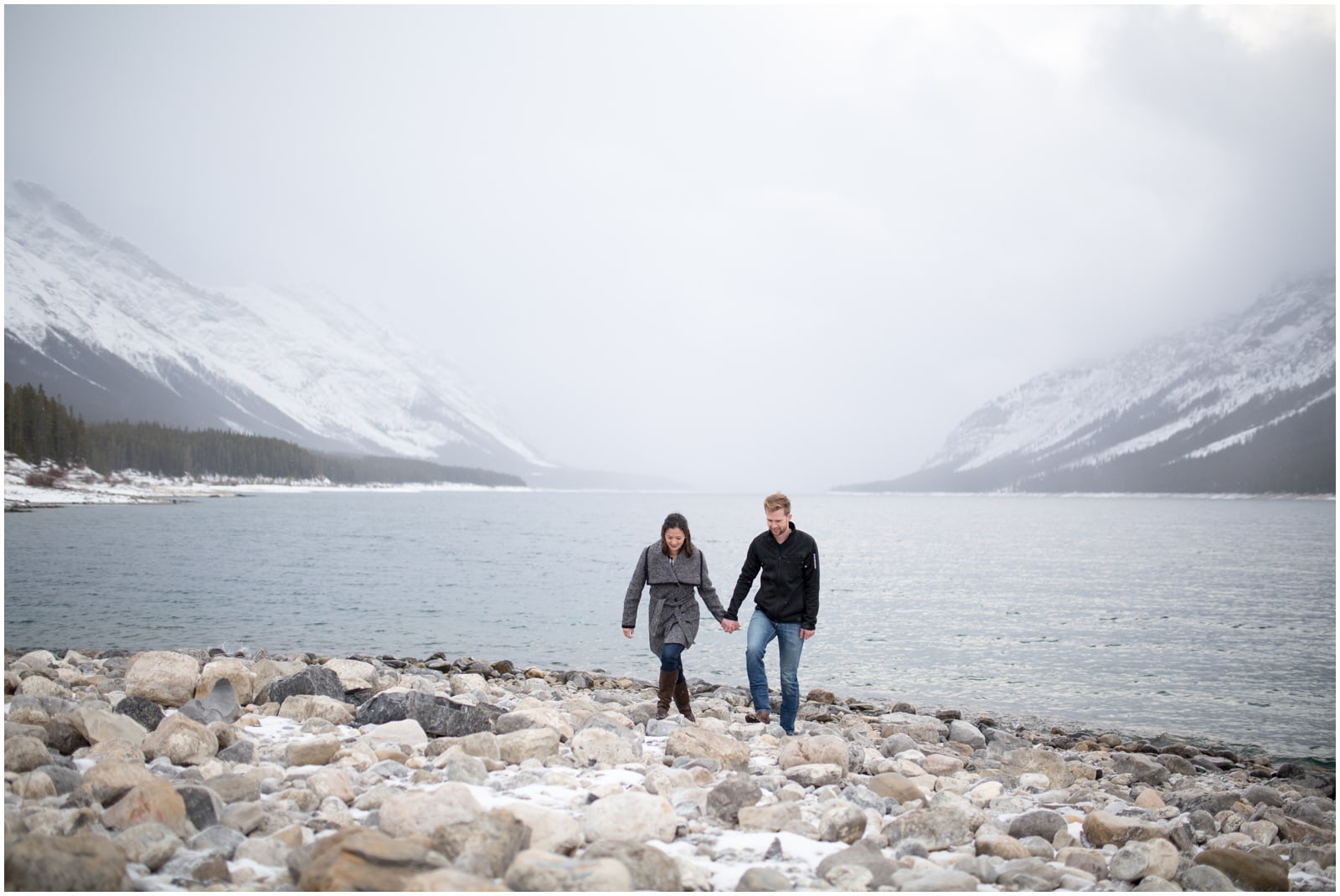 A beautiful adventure engagement session in the Rocky Mountains of Alberta at Barrier Lake, Kananaksis, and Spray Lakes with 360 mountain views and snow