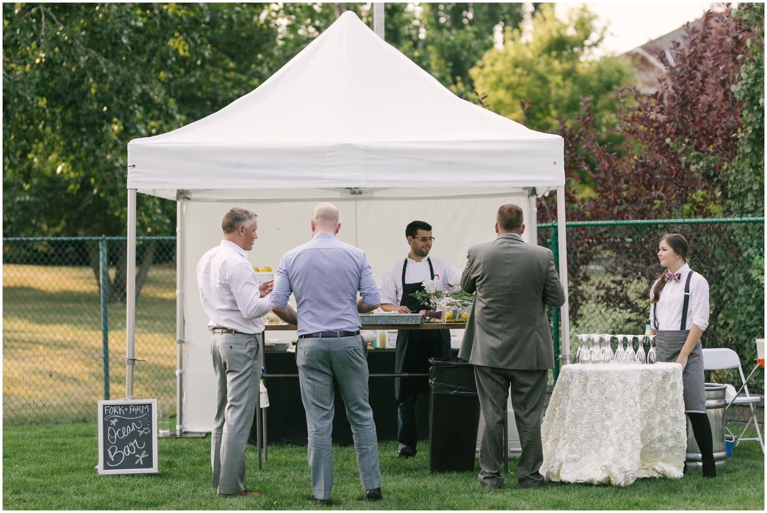 Wedding food tents decorating the tables at a backyard wedding in Calgary