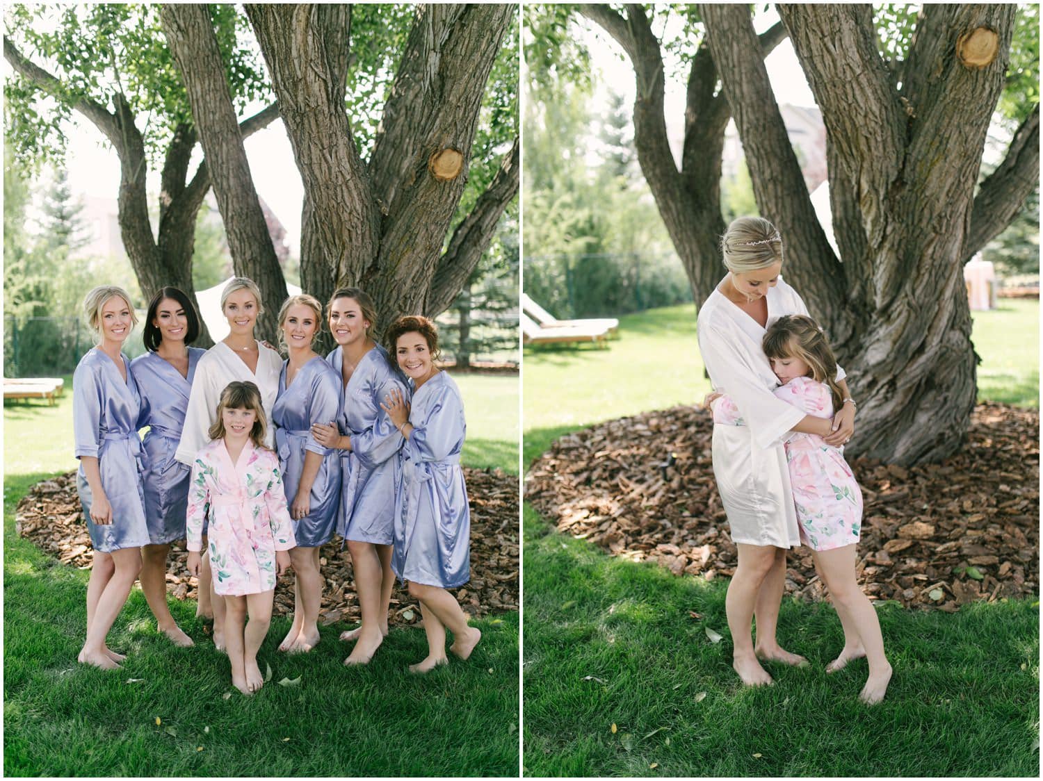 A bride and her maids all in lavendar robes pose in front of a tree and the bride's daughter also in a robe giving her a hug