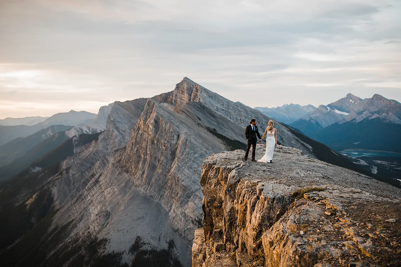 A hiking elopement couple stands on top of EEOR in Kananaskis
