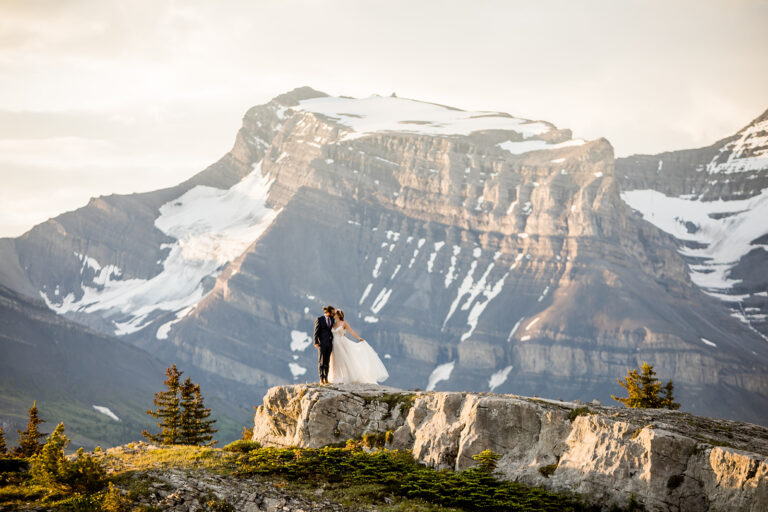 Alberta backcountry camping elopement with bride and groom dancing in front of the mountains