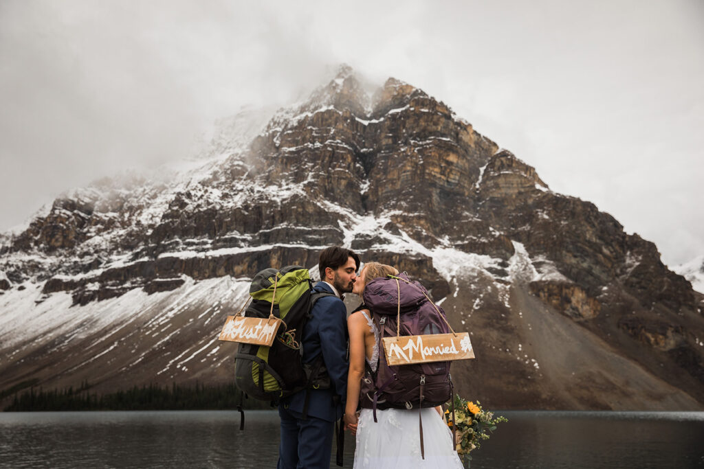 Bow lake banff hiking elopement with signs in front of mountain