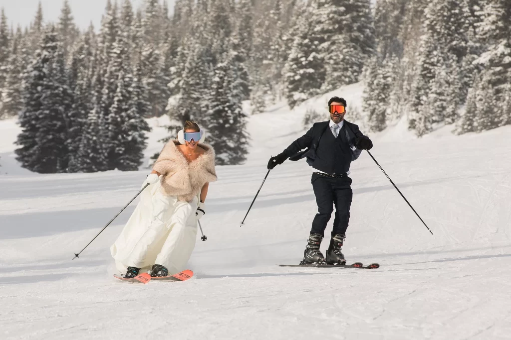 A couple skis down a hill during their Lake Louise ski elopement
