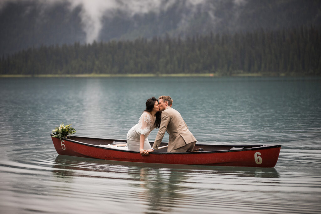 A couple leans in for a kiss during their adventure elopement in Banff National Park
